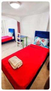 a bedroom with a red bed and a table at Cosy Duplex" Sidi Bou Said " in Sidi Bou Saïd