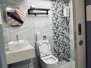 a bathroom with a toilet and a sink and a mirror at Arte cheras luxury family house link MRT in Kuala Lumpur