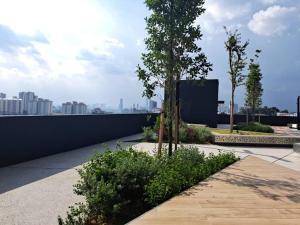 a garden on the roof of a building with trees at Arte cheras luxury family house link MRT in Kuala Lumpur