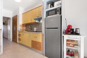 a kitchen with a stainless steel refrigerator with a microwave at Casa Nicole Sea View in Costa de Antigua