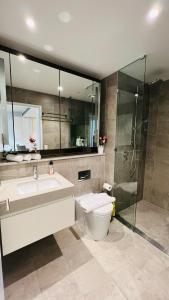 a bathroom with a toilet and a sink and a shower at ChinatownICCHaymarket Adorable 2Br Apt at CBD in Sydney