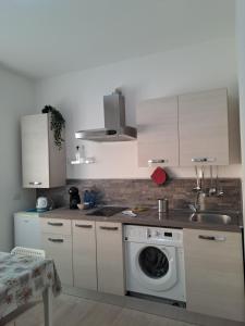 a kitchen with a sink and a washing machine at VACANZA a CASA in Rome