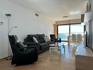 a living room with a couch and a table at V015 - Marina Park in Roses