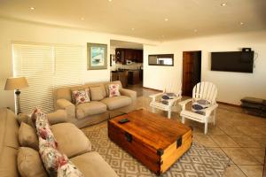 a living room with a couch and a coffee table at Dalene se Seehuis, Langebaan, 8-sleeper in Langebaan