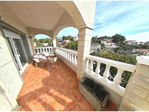 a balcony of a house with a view of the city at Casa con piscina de 8-14 personas in Calafell