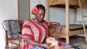 a woman cutting a womans hair in a room at Polly Lodge Bungalow Zanzibar Kiwengwa in Kiwengwa