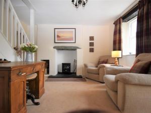 a living room with a couch and a fireplace at 3 Bed in Eskdale SZ416 in Santon Bridge