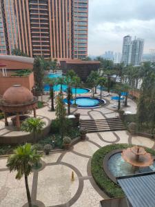 an aerial view of a park with two pools at Bukit Bintang Suite at Times Square KL in Kuala Lumpur