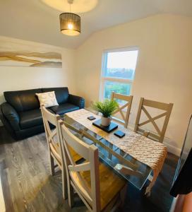 a living room with a table and a couch at Caerau Heights in Newport