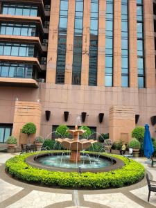 a fountain in front of a building at Bukit Bintang Suite at Times Square KL in Kuala Lumpur