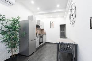a kitchen with a refrigerator and a table and chairs at Urban Loft in Florence