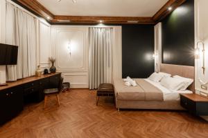 a bedroom with a large bed and a television at King Othon Boutique Hotel in Nafplio