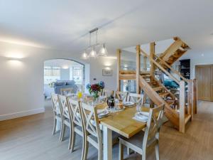 a dining room with a wooden table and chairs at 5 Bed in Barnstaple 85165 in Charles
