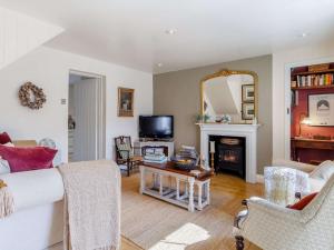 a living room with a couch and a fireplace at 3 bed in Fakenham 85522 in Fakenham