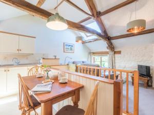 a kitchen and dining room with a wooden table at 2 Bed in Eden Valley SZ209 in Kirkoswald