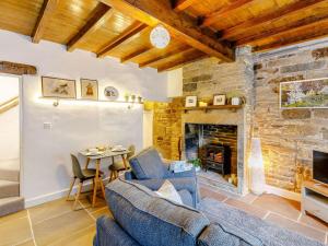 a living room with a couch and a fireplace at 1 Bed in Holmfirth 85392 in Holmfirth