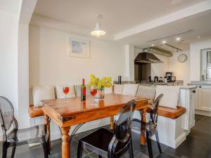a kitchen with a wooden table with wine glasses at 4 Bed in Aberdovey 87520 in Aberdyfi