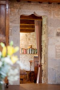 een kamer met een deuropening met een gordijn en een tafel bij Can Feliu, Masia Stone House, Apartment and Ground-Floor apartment, Sant Daniel-Girona in Girona