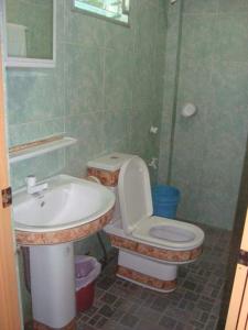 a bathroom with a toilet and a sink at HMC Guesthouse - Malapascua Island Air-conditioned Room #2 in Logon
