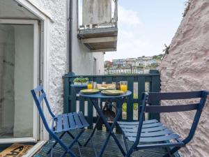 a blue table and chairs on a balcony at 2 Bed in Brixham 88019 in Brixham
