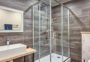 a bathroom with a shower and a sink at VIP apart 703 in Tbilisi City