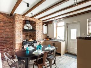 a kitchen and dining room with a table and chairs at 3 Bed in Matlock 86048 in Matlock