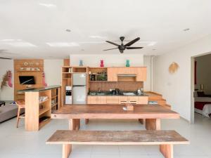 a kitchen with a wooden table in a room at 3BR Del Mar Beach Villas Near La Plancha Seminyak in Seminyak