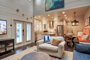 a living room with a couch and a kitchen at 16 Palms by AvantStay Luxury Pool Playscape in Port Aransas
