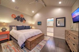 a bedroom with a bed and a flat screen tv at 16 Palms by AvantStay Luxury Pool Playscape in Port Aransas