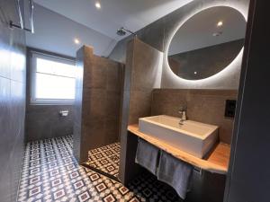a bathroom with a sink and a mirror at Haus Bergquell App 6 in Willingen