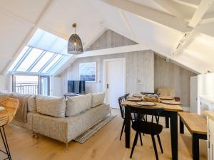 a living room with a couch and a table at 3 Bed in Ogmore-by-Sea 86494 in Southerndown