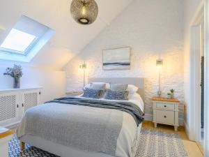 a bedroom with a bed with blue pillows on it at 3 Bed in Ogmore-by-Sea 86494 in Southerndown