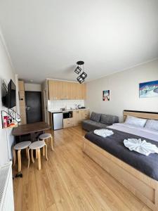 a bedroom with a large bed and a kitchen at Rezi's Apartment Vista Gudauri in Gudauri
