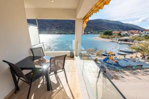 a balcony with a view of a marina at Holidays Roko - Sea View Apartments with Pool in Grebaštica