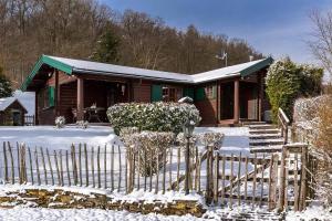 a house with a fence in the snow at Blockhaus am Diemelsee in Sudeck