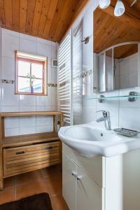 a bathroom with a white sink and a window at Blockhaus am Diemelsee in Sudeck +17 photos
