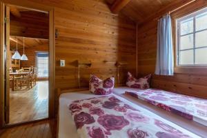 a bedroom with two beds in a log cabin at Blockhaus am Diemelsee in Sudeck