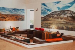 a living room with a large painting on the wall at Hostal Schilling in El Calafate