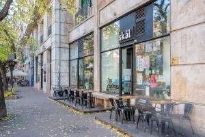 a tables and chairs in front of a store at Extra Central New & Stylish Studio in Budapest