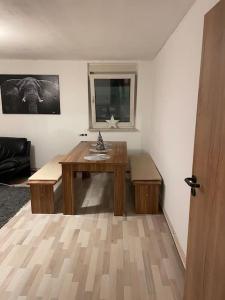 a room with a wooden table in a room at 3 Room City Apartment 90m2 in Heilbronn