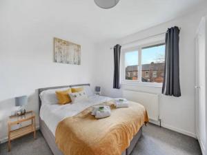 a bedroom with a large bed and a window at Pass the Keys 3 bedroom modern house in Withington in Manchester