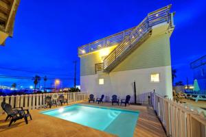 a house with a swimming pool at night at Stella Maris Golf Cart Zone Near Beach Rooftop in Port Aransas