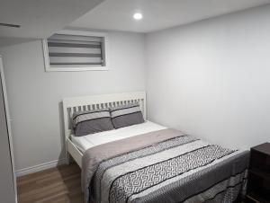 biała sypialnia z łóżkiem z 2 poduszkami w obiekcie House of Pleasantness w mieście Hamilton