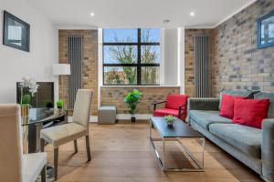 a living room with a couch and a table at Regent's Park Serviced Apartments by MySquare in London