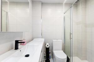 a white bathroom with a sink and a toilet at Espanatour MENORCA in Dehesa de Campoamor +9 photos