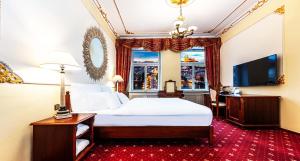 a hotel room with a bed and a television at Hotel General Old Town Prague in Prague