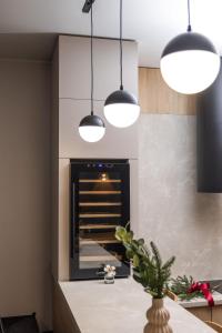 a kitchen with two pendant lights and a fireplace at Black & White Villas by Fomich Hotels Group in Bukovel