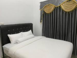 Postel nebo postele na pokoji v ubytování Homestay Telage Bulan