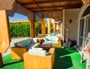 a living room with a couch and a table at Luxury Royal Blue Family Villa 8pers private pool in Hurghada