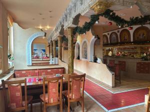 a restaurant with a table and chairs and a counter at Mansfelder Hof in Lutherstadt Eisleben